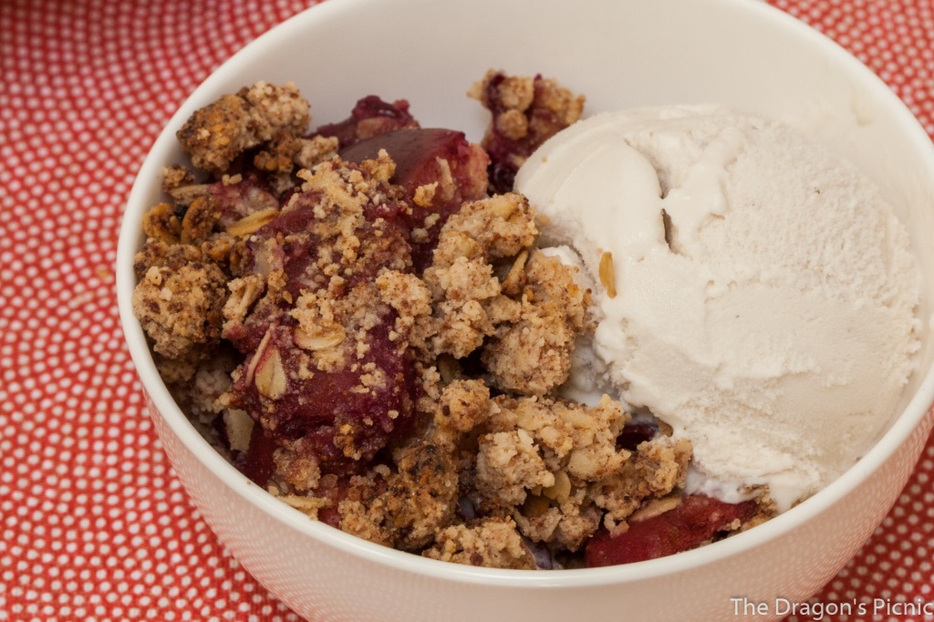Bowl of apple and blackberry crumble (vegan and gluten free) and ice-cream. 